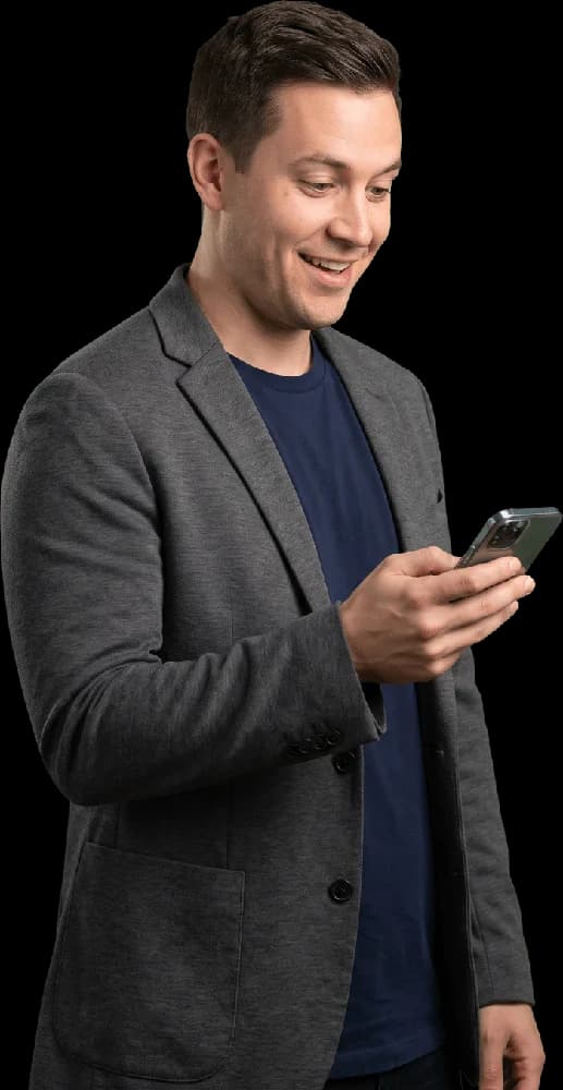 A founder checking a message with a smile
